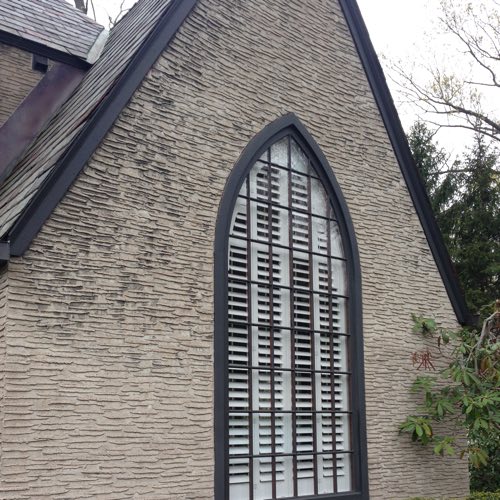 outdoor face of brick home with plantation shutters